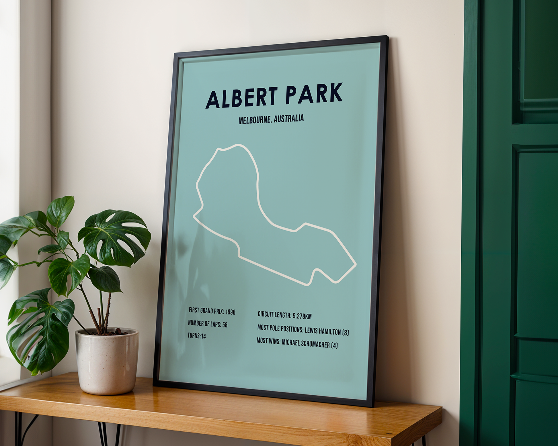 Framed map of Albert Park Circuit in Melbourne, Australia on a wooden shelf with a plant.