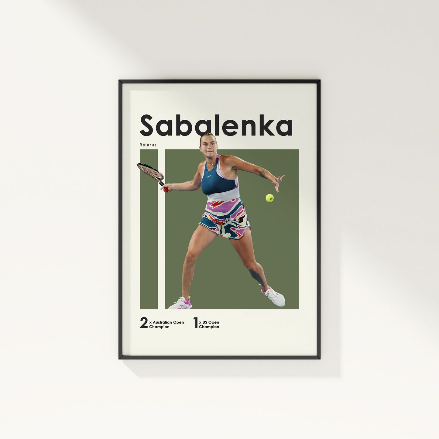 framed poster mockup hanging on a white wall. poster of tennis player Aryna Sabalenka hitting a forehand.
