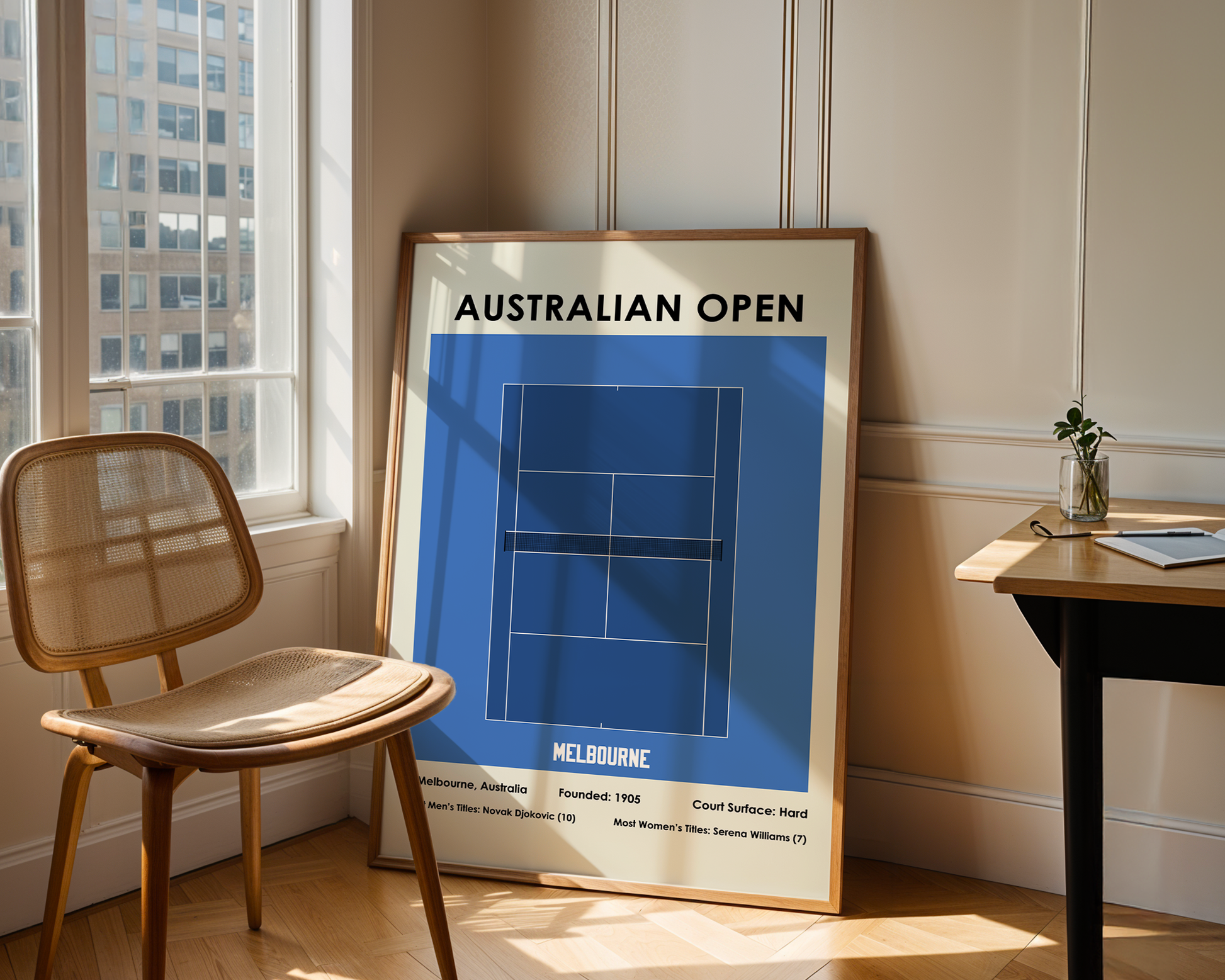 Framed poster of the Australian Open tennis court design in a room with a chair and table.