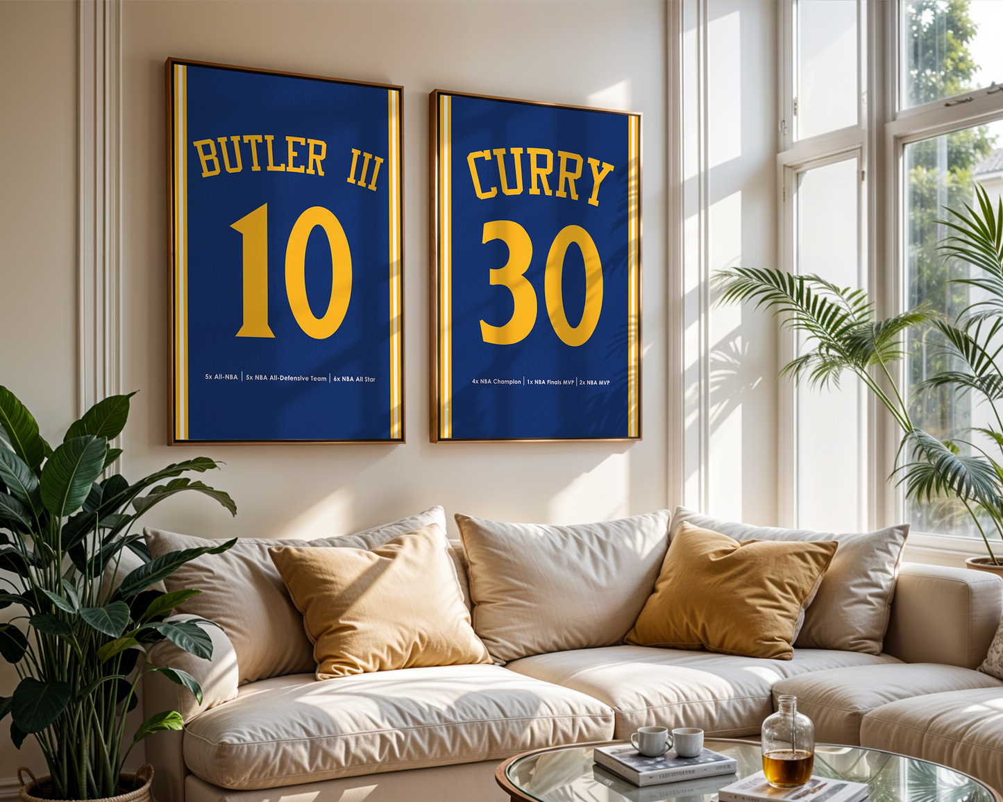 Two framed sports jerseys with names and numbers on a wall above a couch in a bright living room.