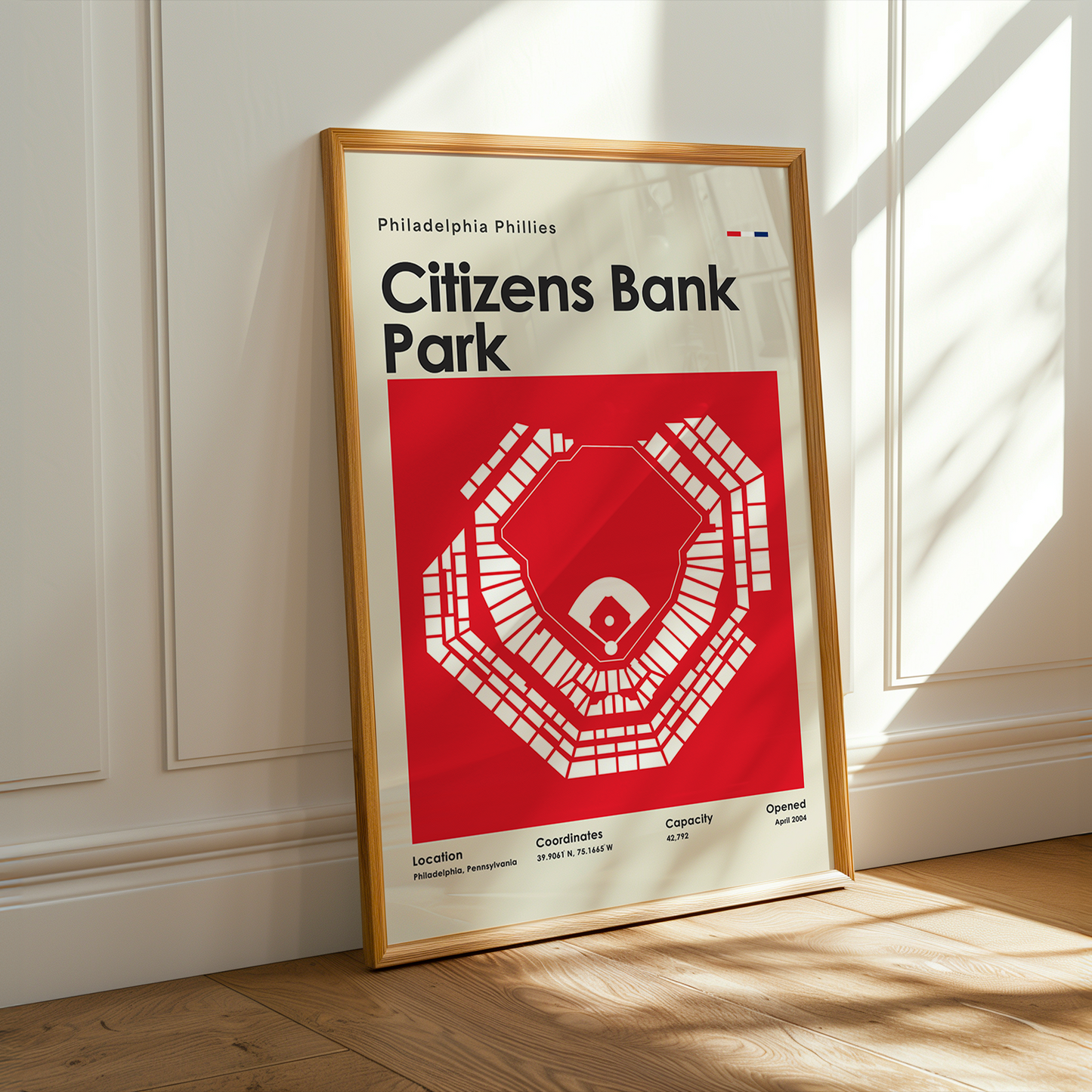 Framed poster of Citizens Bank Park in a room with sunlight streaming through a window.