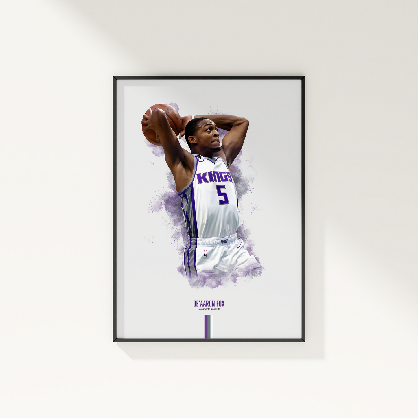 framed poster mockup hanging on a white wall. poster of basketball player de'aaron fox dunking for the Sacramento Kings.