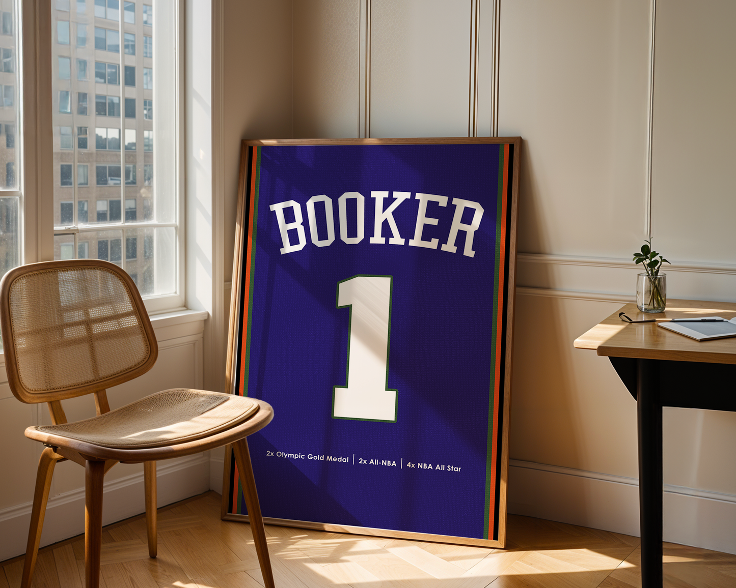 Framed sports jersey with 'Booker' and number '1' in a room with a window and chair.