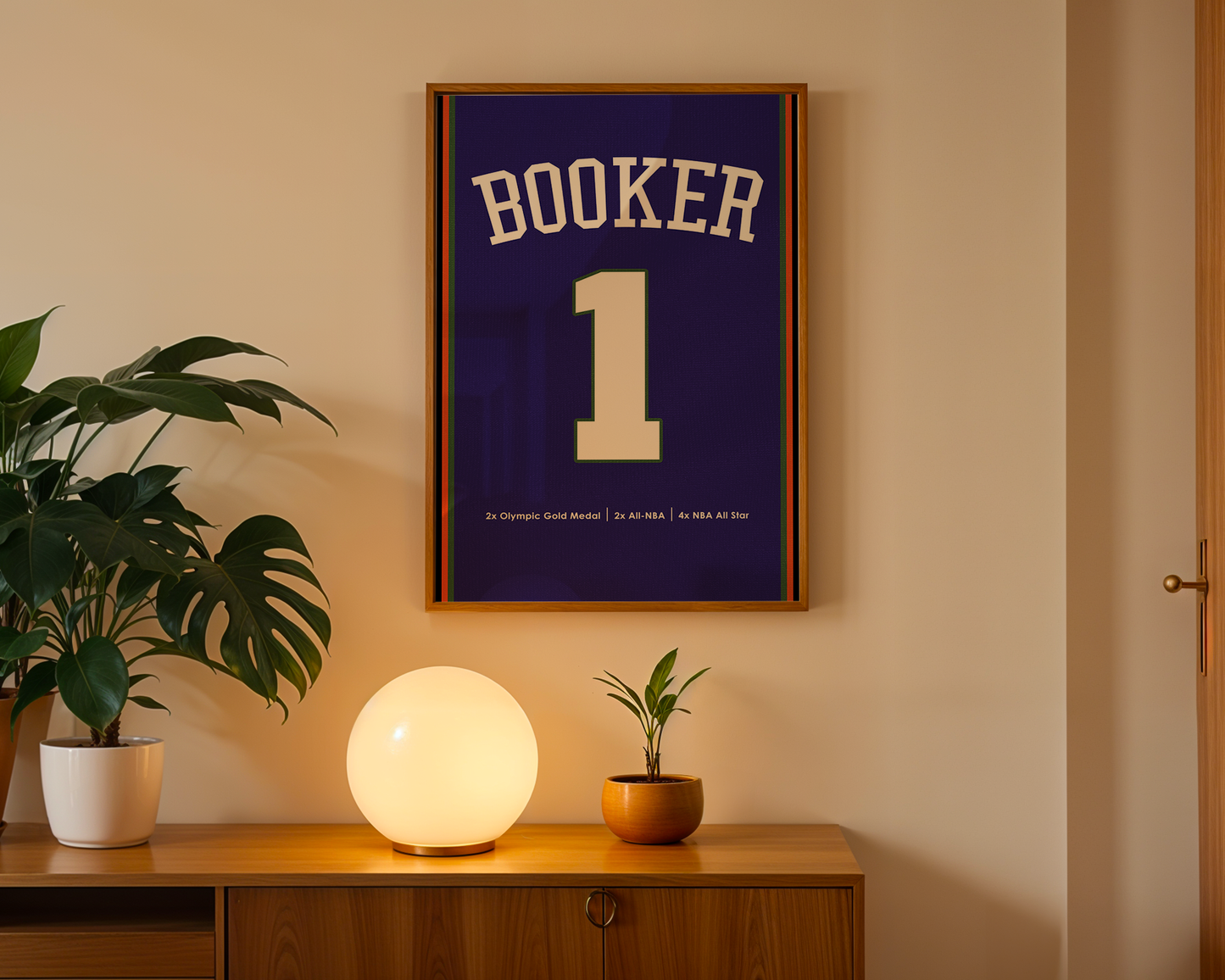Framed jersey with 'Booker 1' on a wall above a wooden cabinet with decorative items.