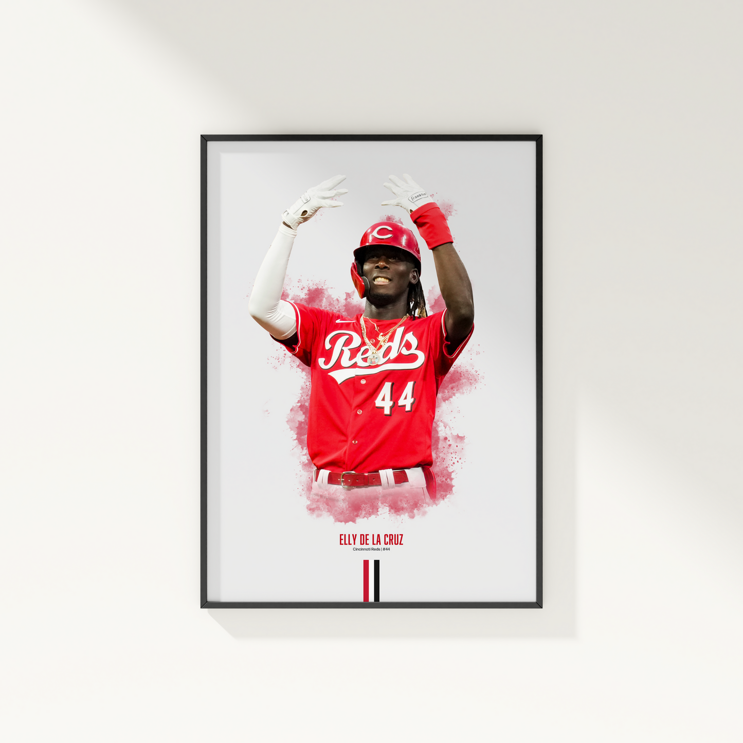 framed poster mockup hanging on a white wall. poster of baseball player elly de la cruz celebrating for the cincinnati reds.