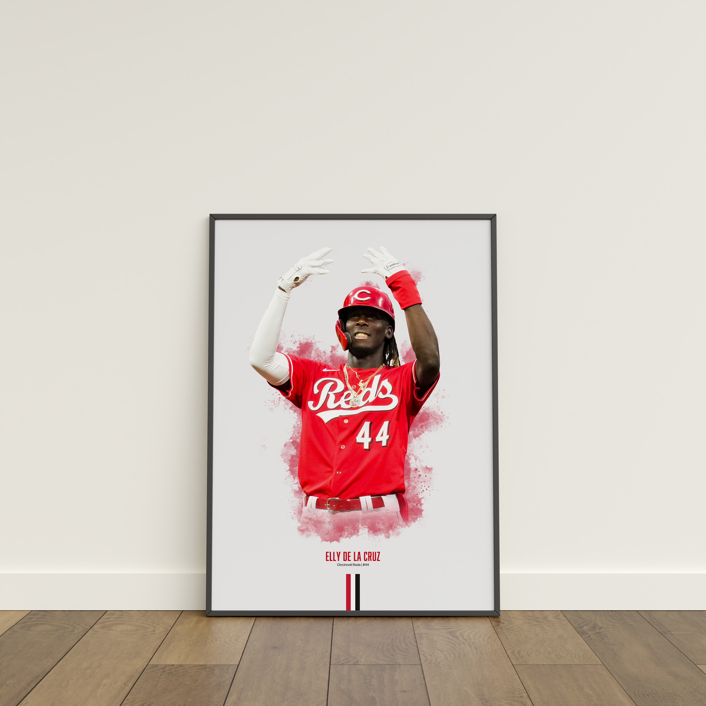 framed poster mockup leaning on a white wall. poster of baseball player elly de la cruz celebrating for the cincinnati reds.