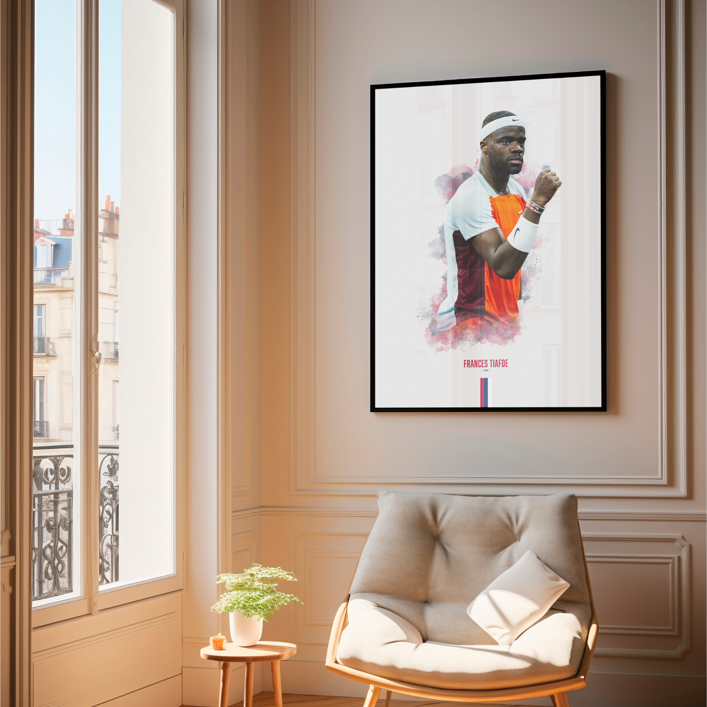 Framed poster of tennis player Frances Tiafoe on a wall above a chair.