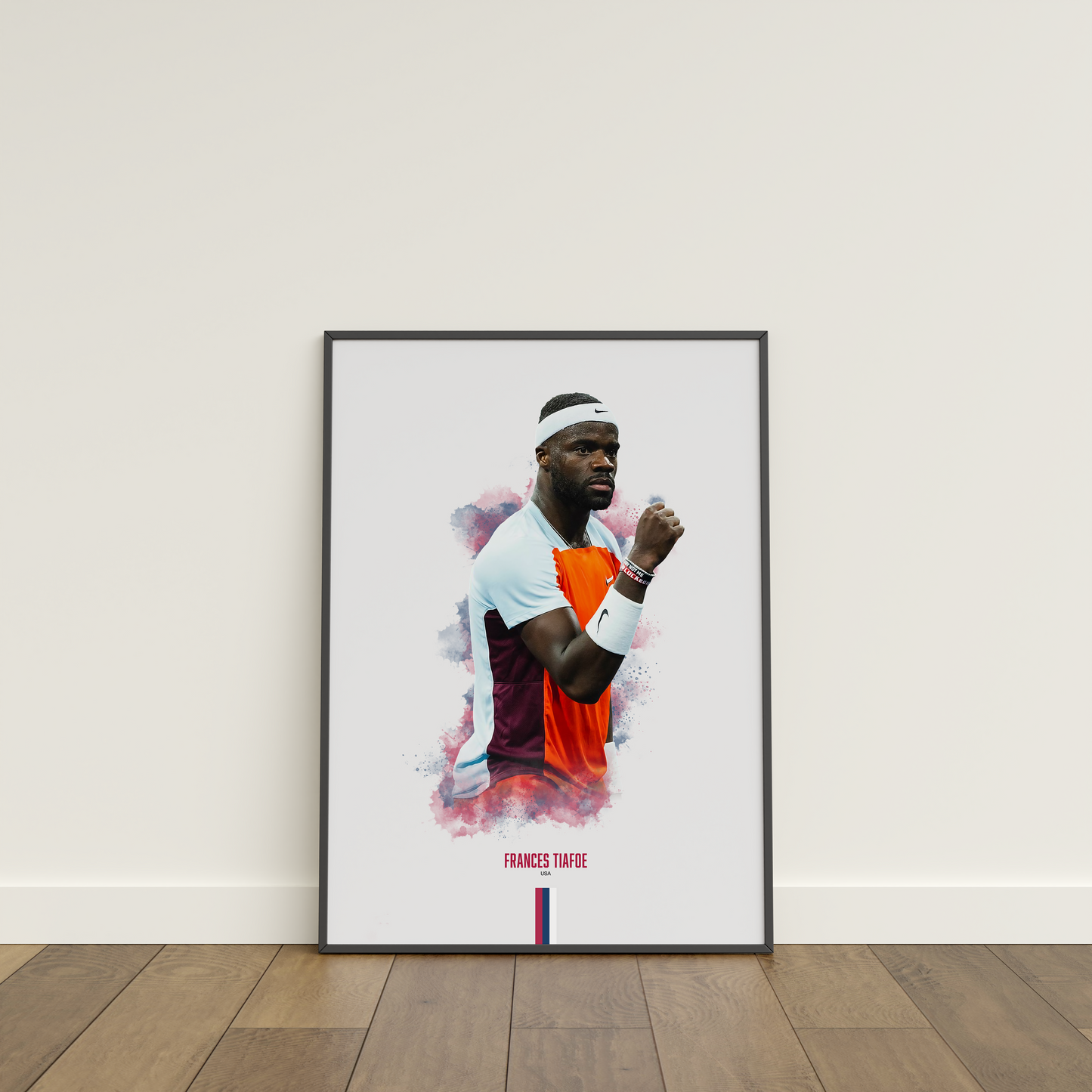 Framed poster of tennis player Frances Tiafoe on a white wall.