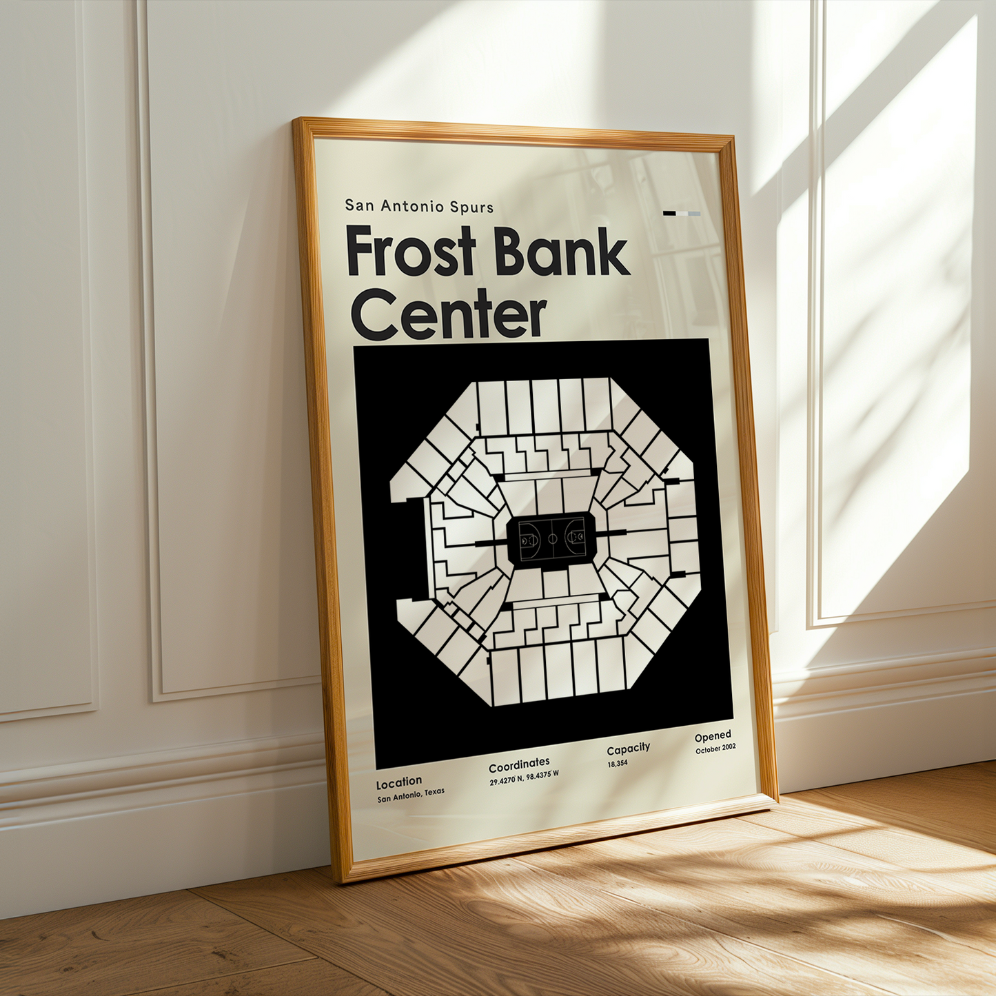 Framed poster of Frost Bank Center in a room with sunlight streaming through a window.