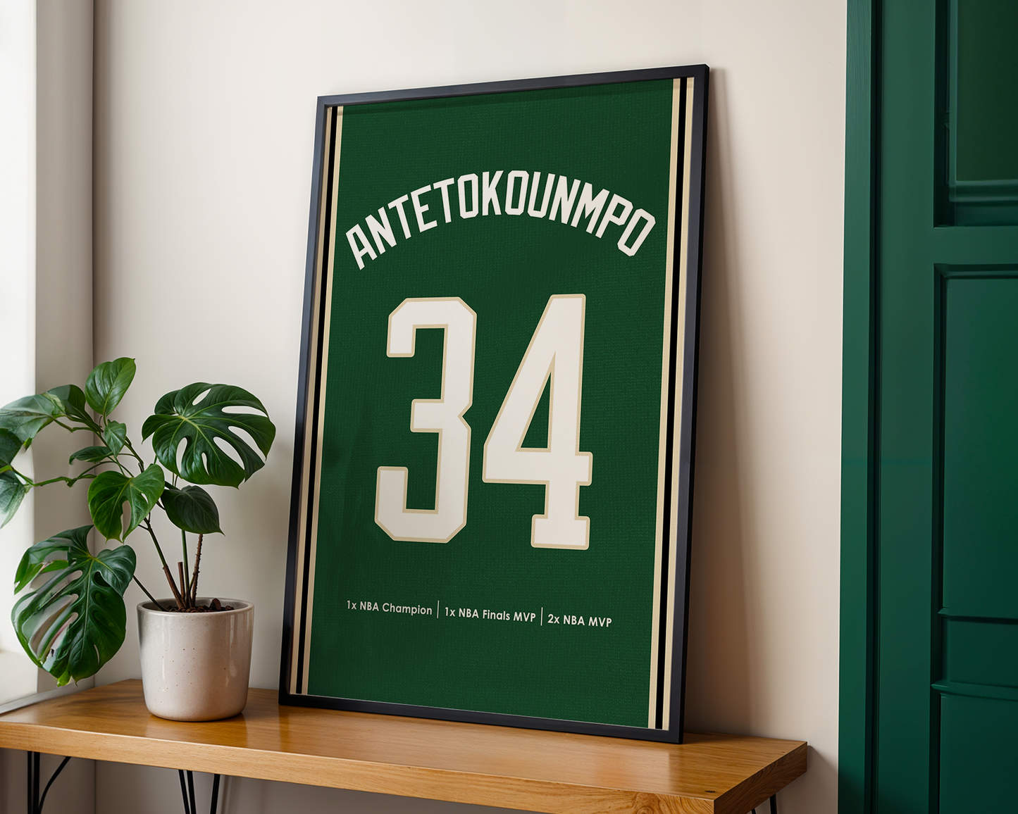 Framed sports jersey with 'ANTETOKOUNMPO 34' on a wooden shelf.