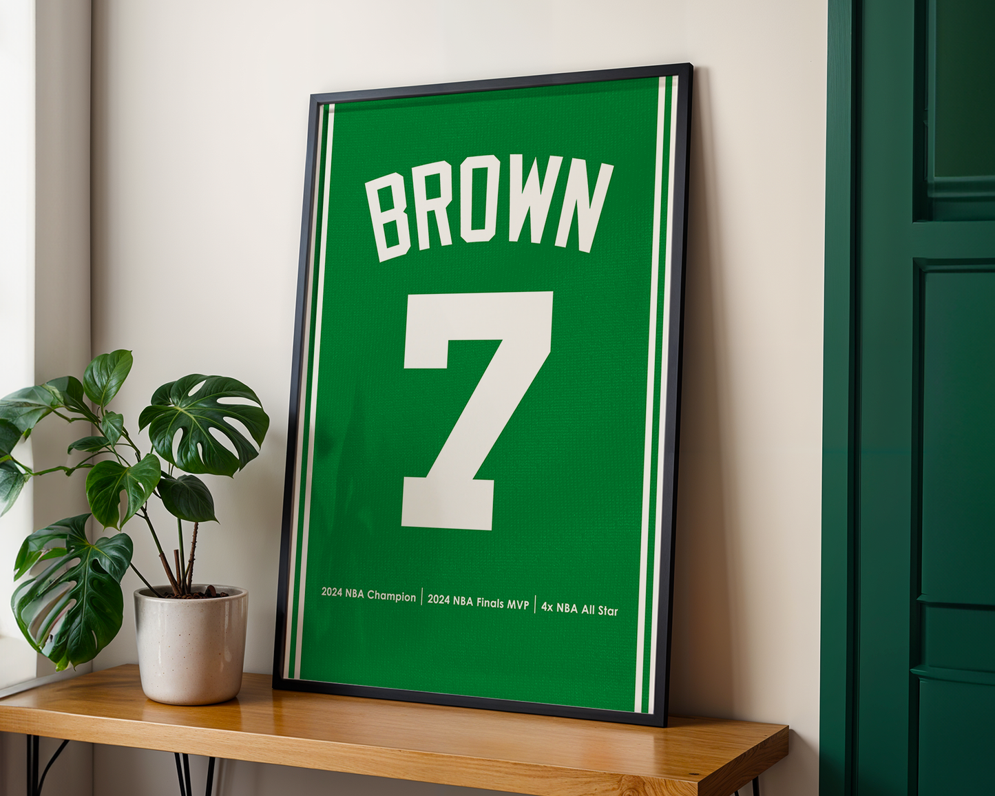 Framed sports jersey with 'Brown' and number '7' on a wooden shelf.