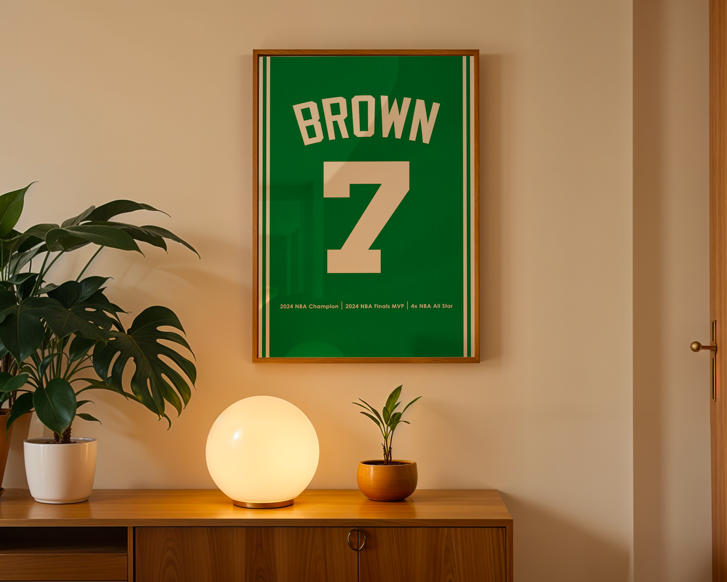 Framed sports jersey with 'Brown' and number '7' on a wall above a wooden cabinet with decorative items.