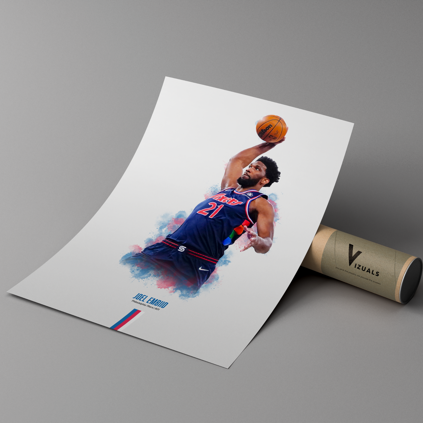 poster mockup leaning on a branded cardboard tube. poster of basketball player joel embiid dunking for the philadelphia 76ers.