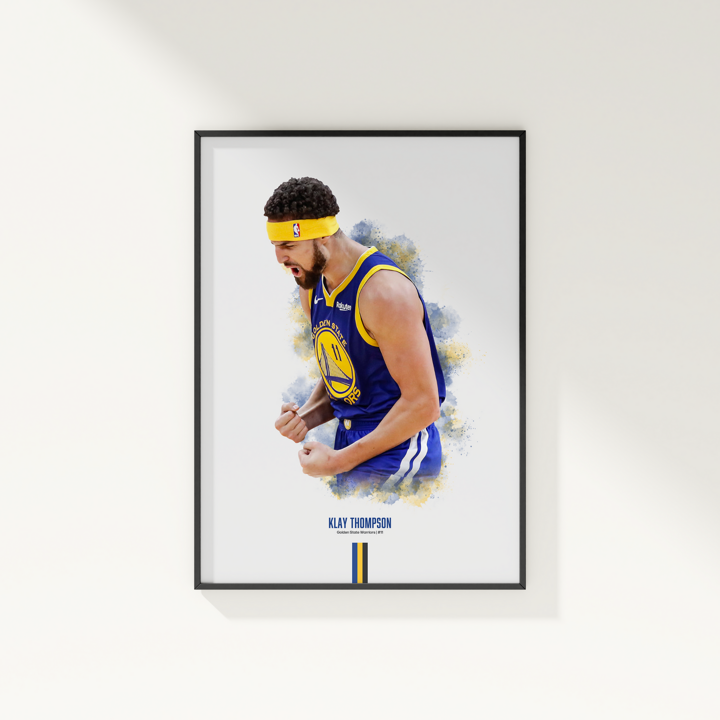 framed poster mockup hanging on a white wall. poster of basketball player klay thompson celebrating for the golden state warriors.