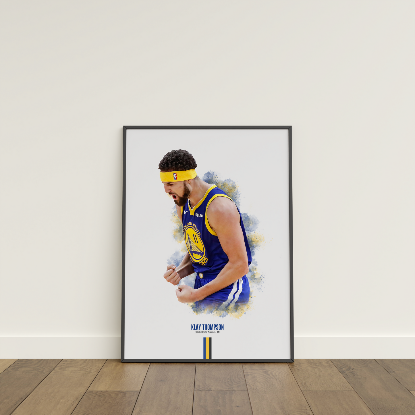 framed poster mockup leaning on a white wall. poster of basketball player klay thompson celebrating for the golden state warriors.
