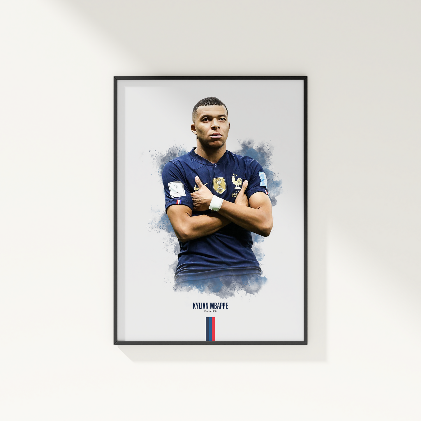 framed poster mockup hanging on a white wall. poster of soccer player Kylian Mbappe celebrating for France.