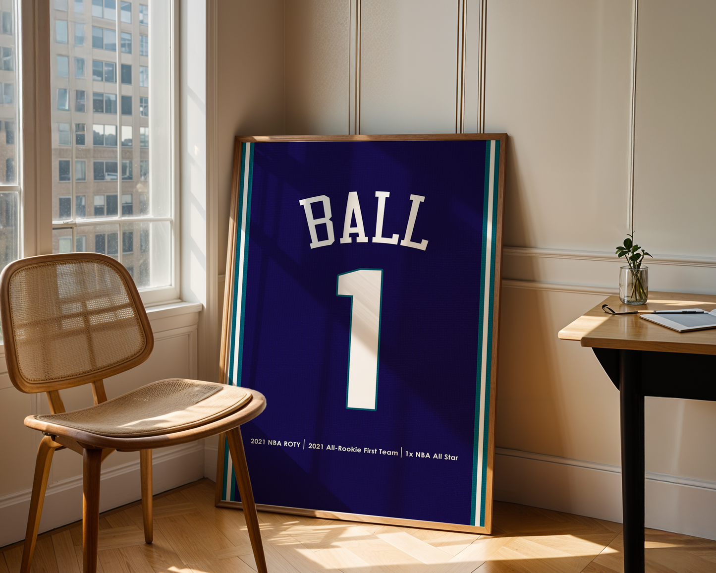 Framed sports jersey with 'BALL' and number '1' in a room with a window and chair.