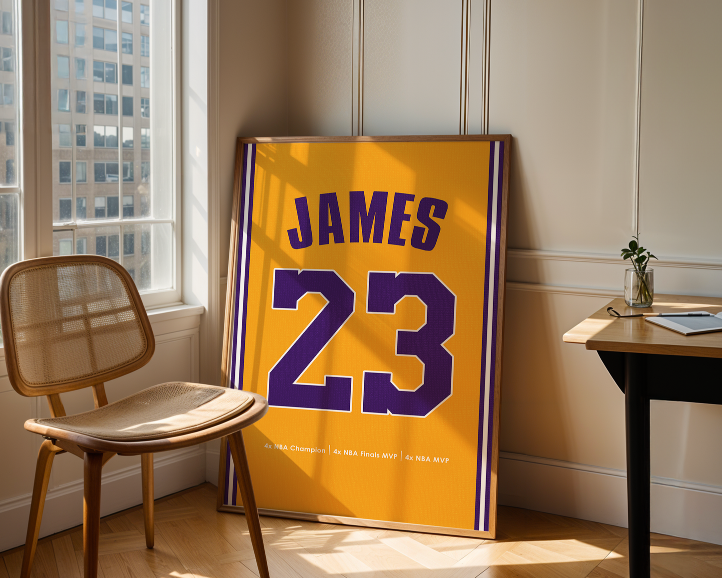Framed jersey with 'JAMES 23' in a room with a chair and table.