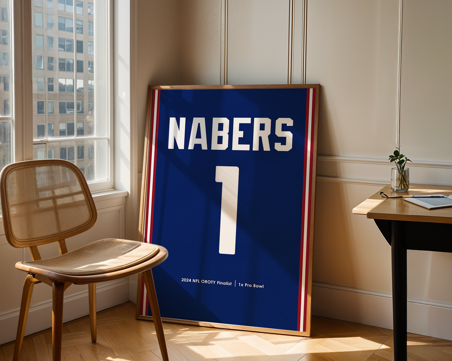 Framed sports jersey with 'NABERS' and number '1' in a room with a chair and table.