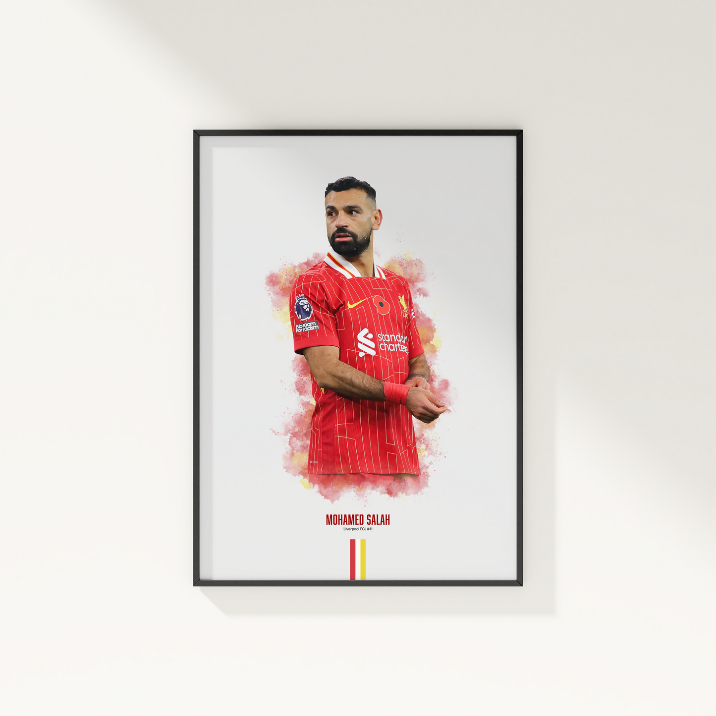framed poster mockup hanging on a white wall. poster of soccer player mohamed salah playing for Liverpool fc.