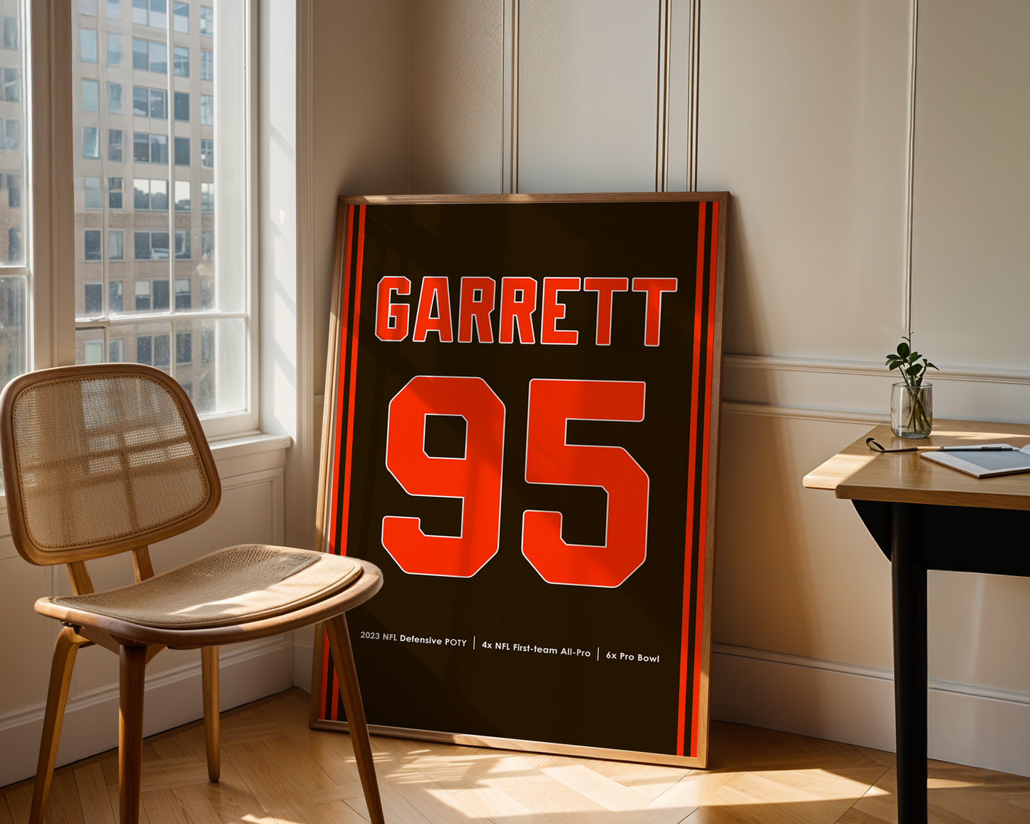 Framed sports jersey with 'Garrett 95' in a room with a chair and table.