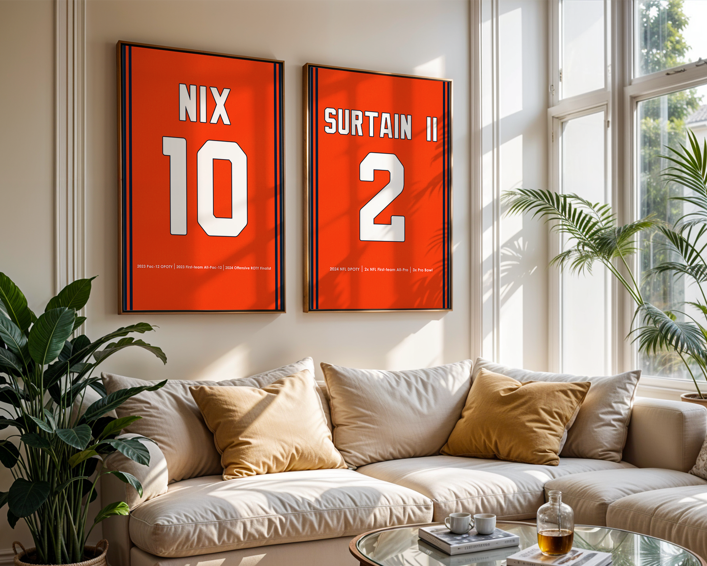 Two framed sports posters on a wall above a beige sofa with decorative pillows.