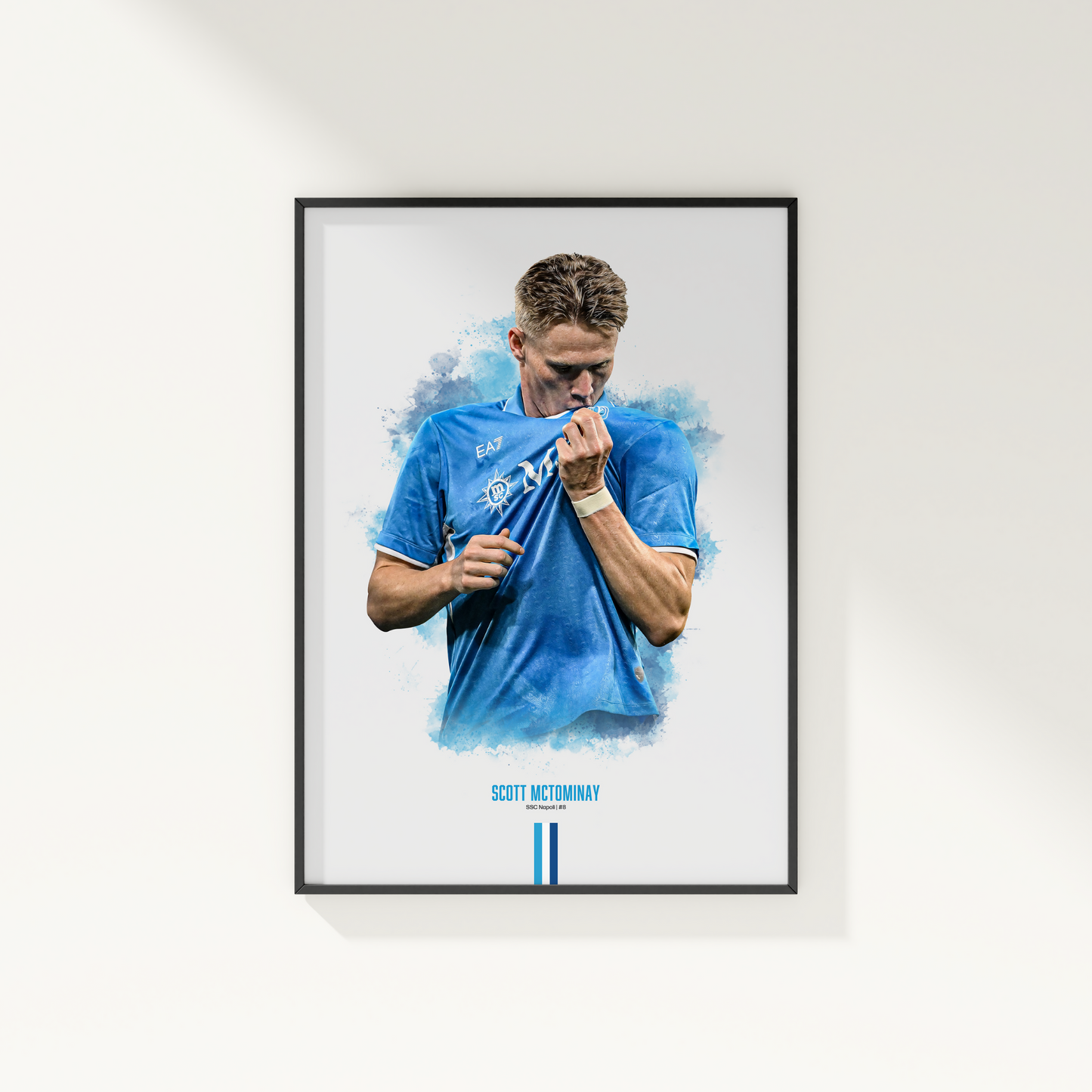 Framed poster print of soccer player Scott McTominay, wearing a Napoli jersey, on a white wall.