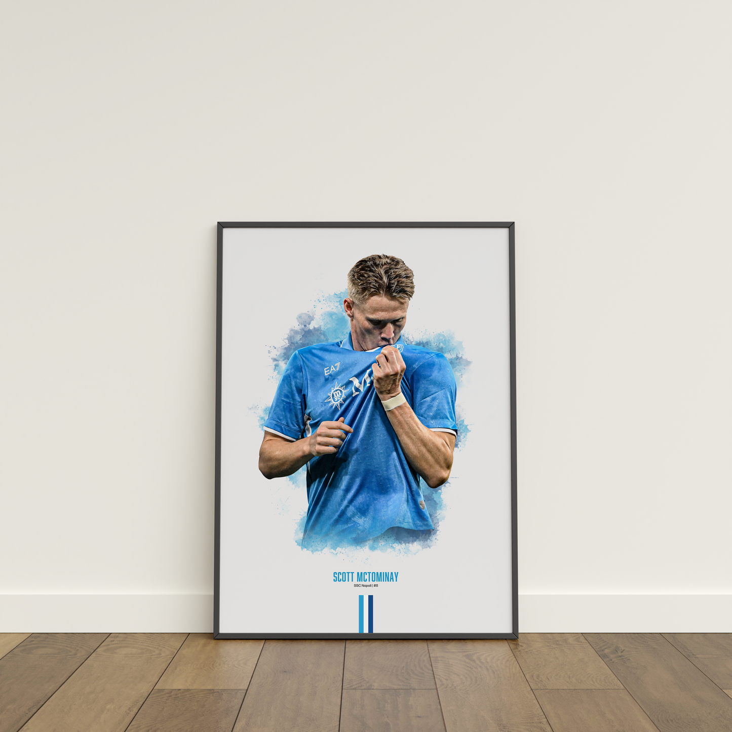 Framed poster print of soccer player Scott McTominay, wearing a Napoli jersey, on a white wall.