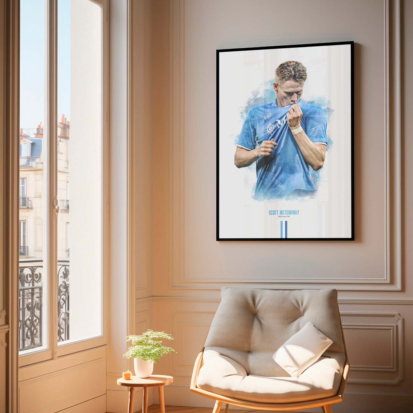Framed poster print of soccer player Scott McTominay, wearing a Napoli jersey, on a wall above a chair.