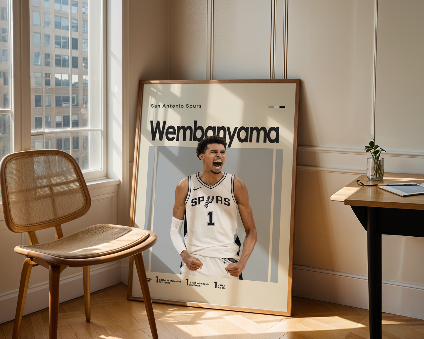 Framed sports poster of a basketball player in a room with a chair and table.