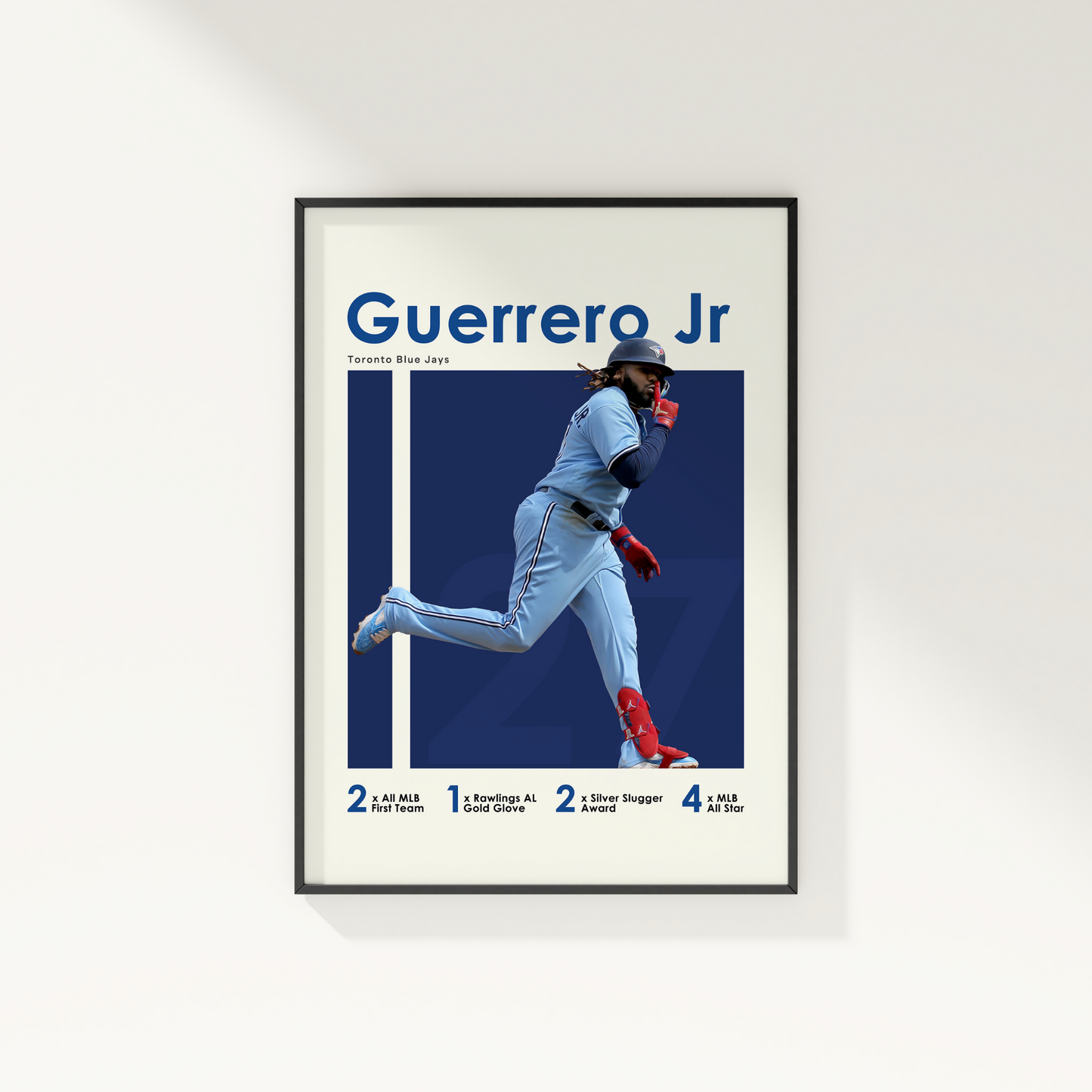 framed poster mockup hanging on a white wall. poster of baseball player vladimir guerrero jr celebrating for the Toronto Blue Jays.