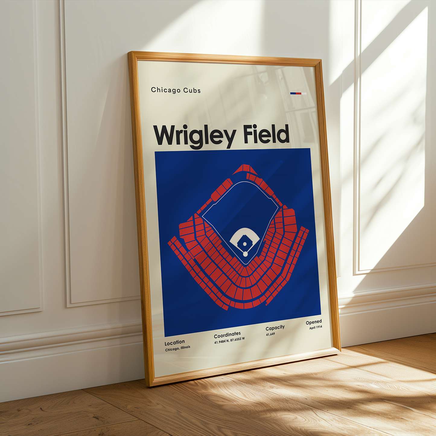 Framed poster of Wrigley Field in a room with sunlight streaming through a window.