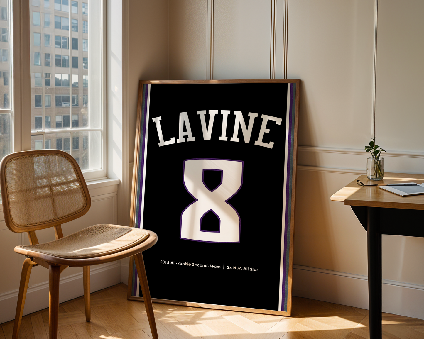 Framed jersey with 'LAVINE 8' in a room with a window and chair.