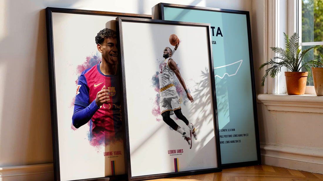 three framed sports prints leaning on a wall next to a window