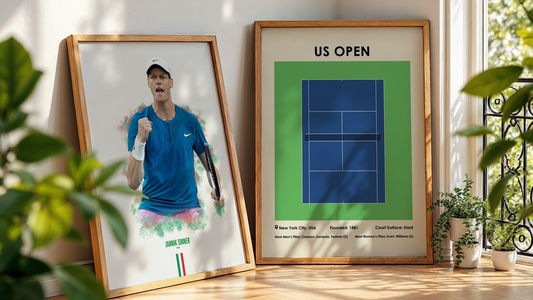 two framed tennis posters leaning on a wall next to a plant
