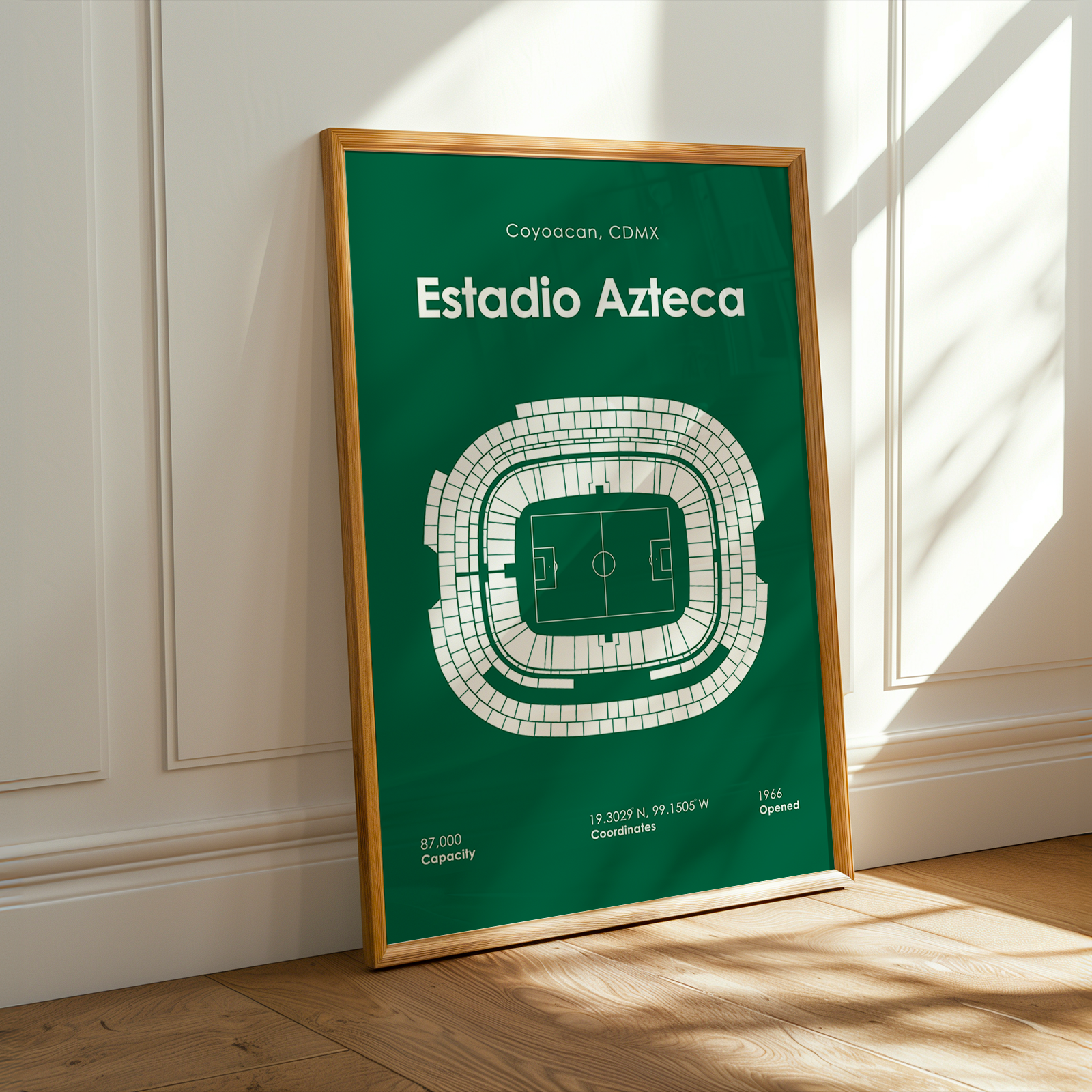 Framed poster of Estadio Azteca on a wall with sunlight casting shadows.