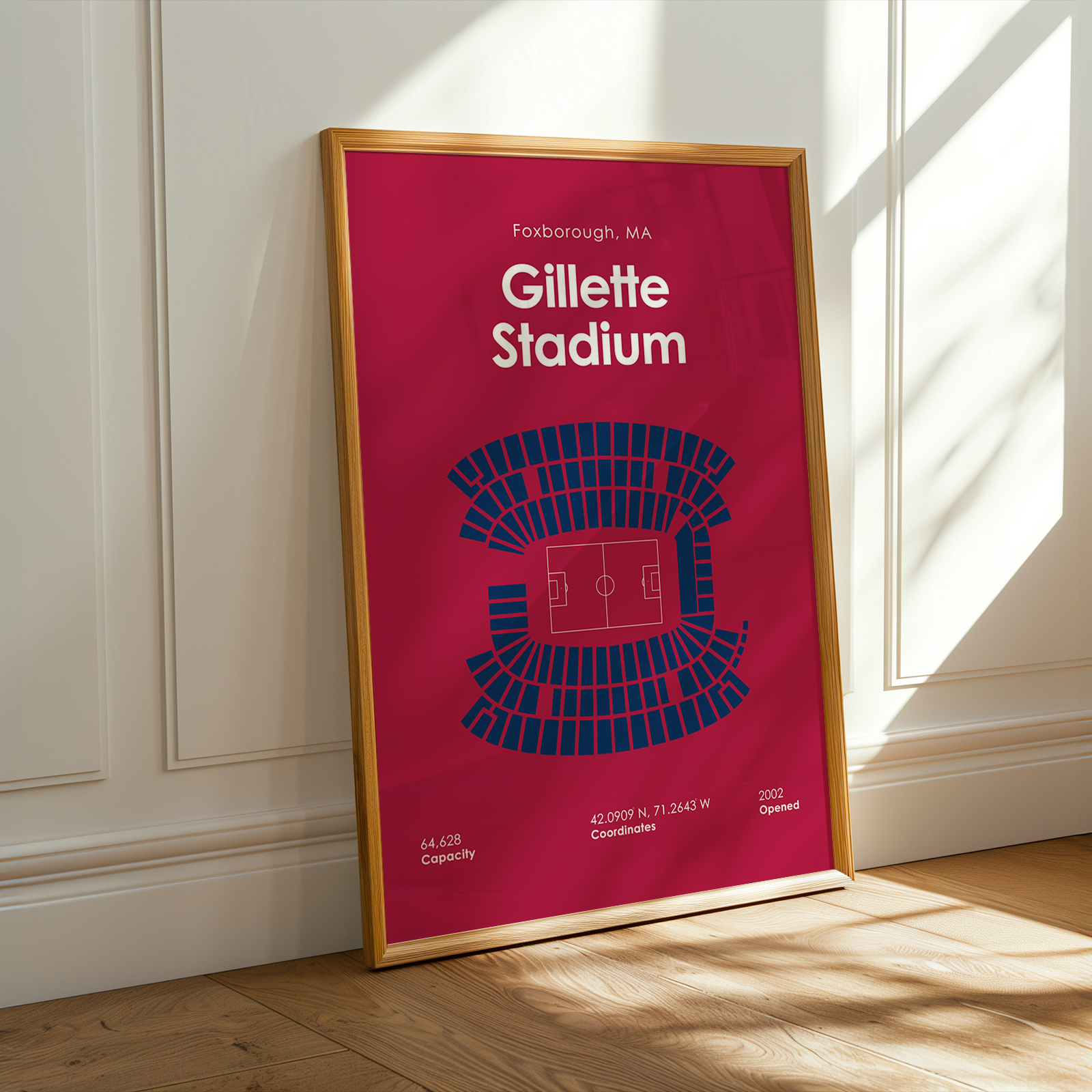 Framed poster of Gillette Stadium design on a wall.
