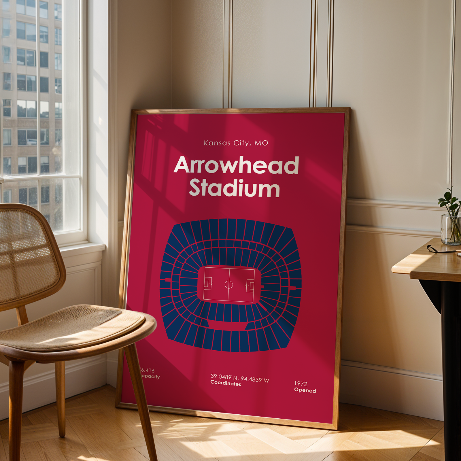 Poster of Arrowhead Stadium in a room with a chair and table.