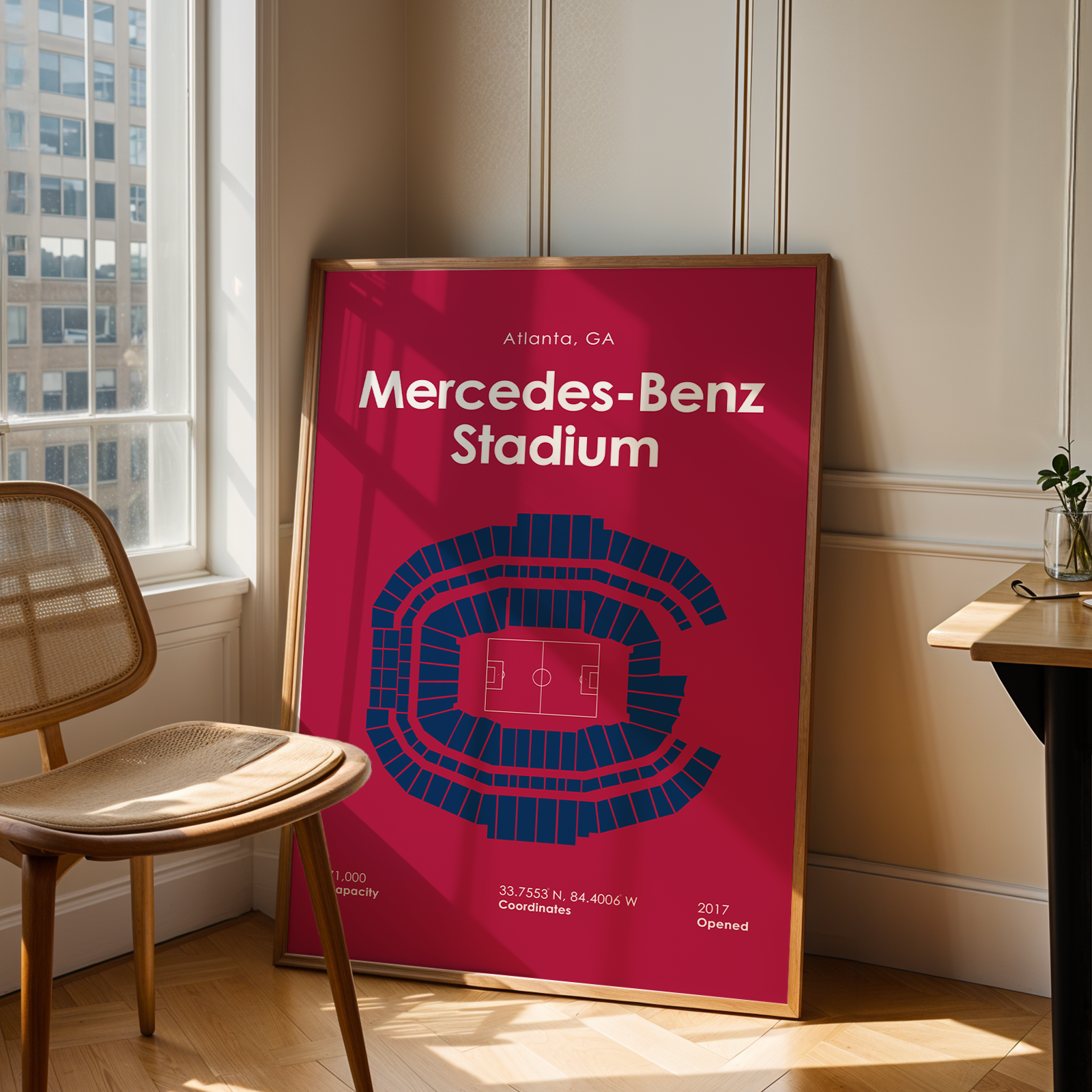 Poster of Mercedes-Benz Stadium in a room with a chair and table.