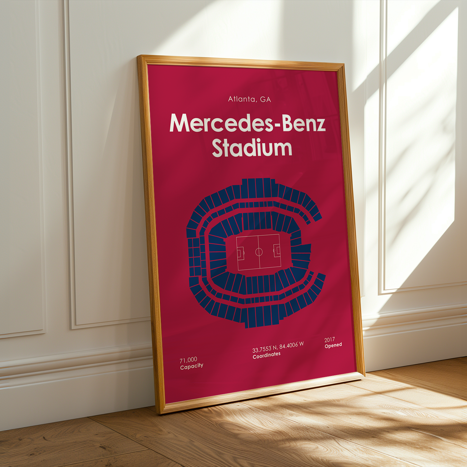 Framed poster of Mercedes-Benz Stadium with seating layout on a wall.