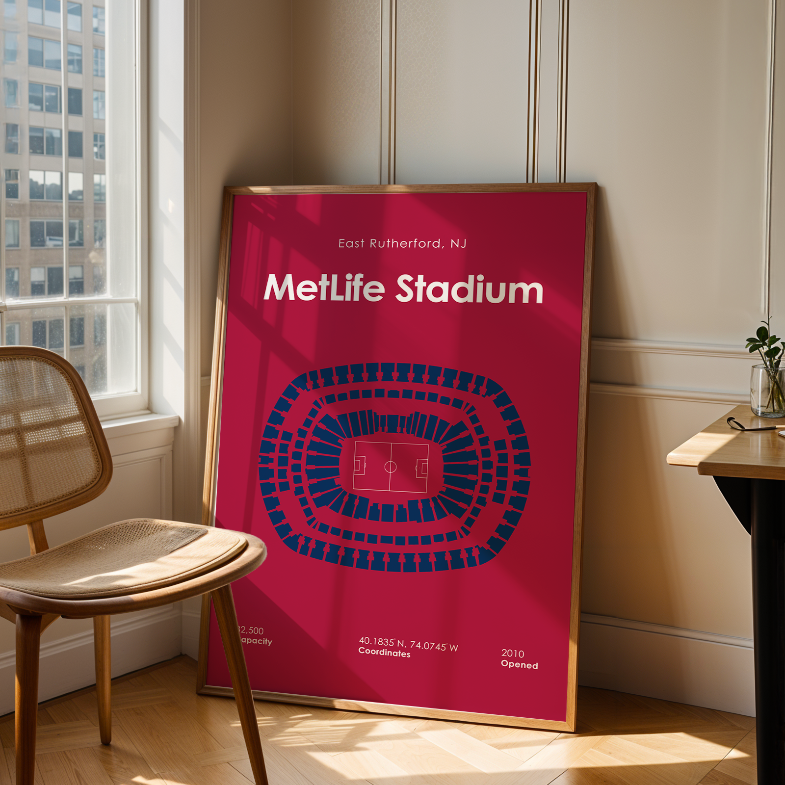 Poster of MetLife Stadium in a room with a chair and table.
