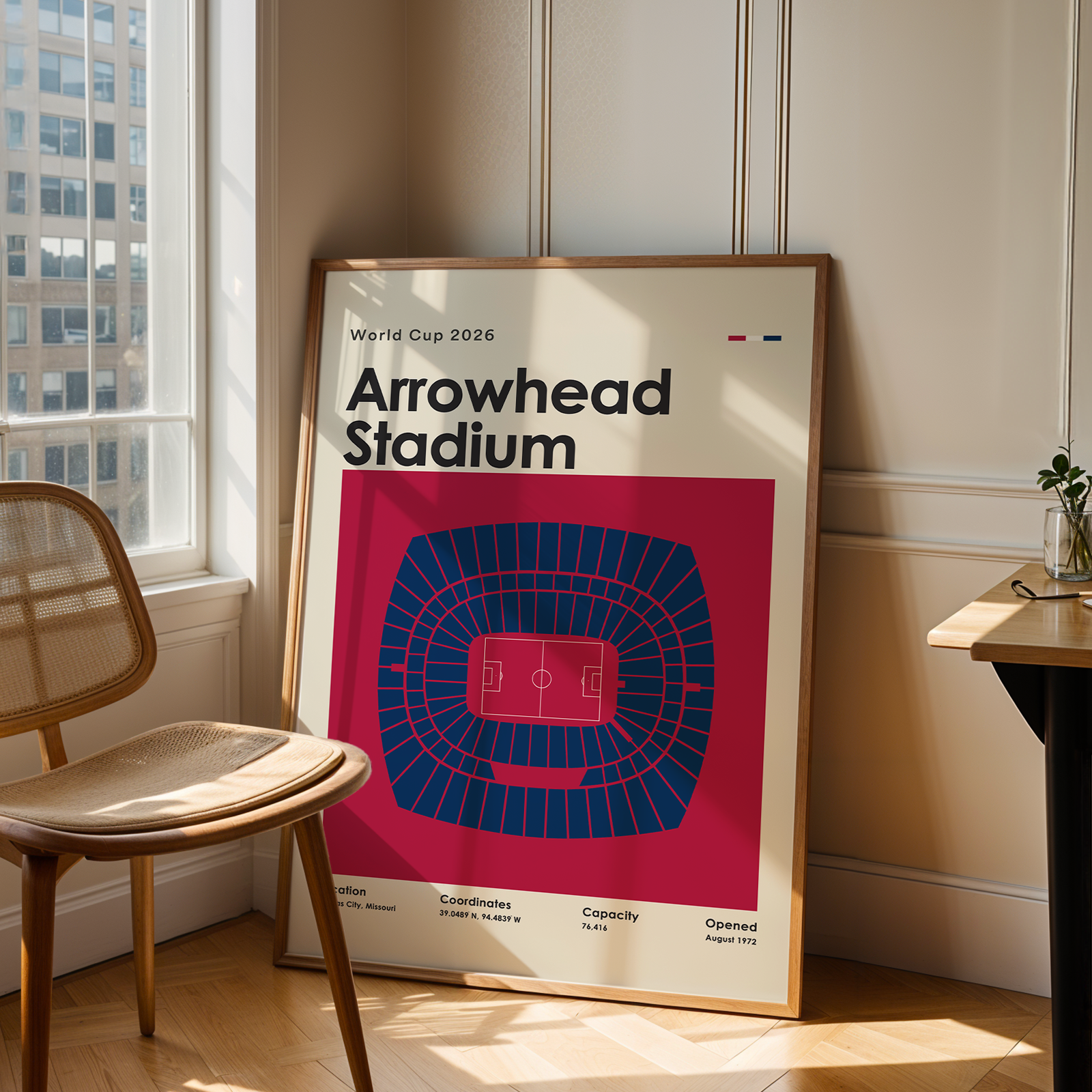 Poster of Arrowhead Stadium in a room with a chair and table.
