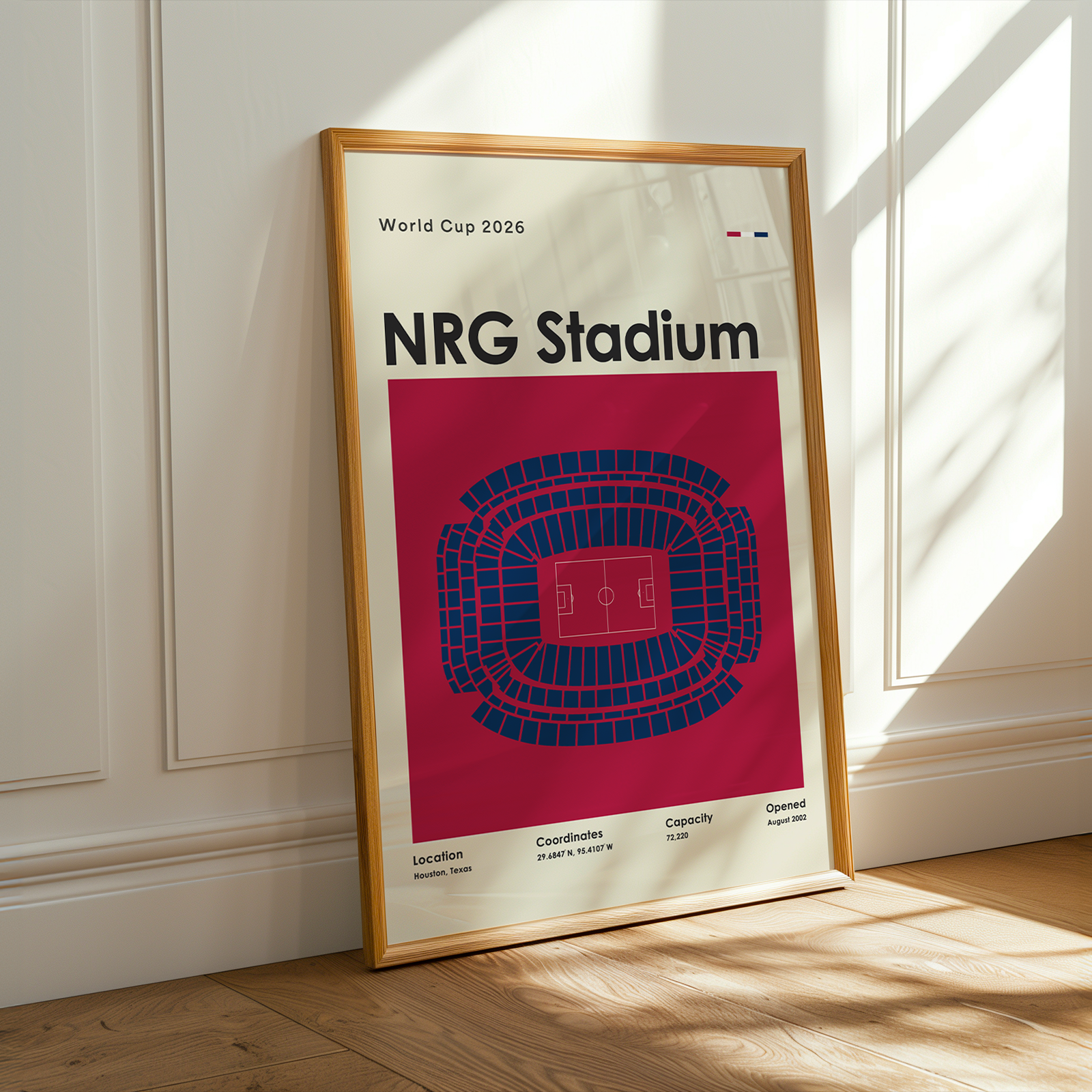 Framed poster of NRG Stadium with seating chart on a wooden floor.