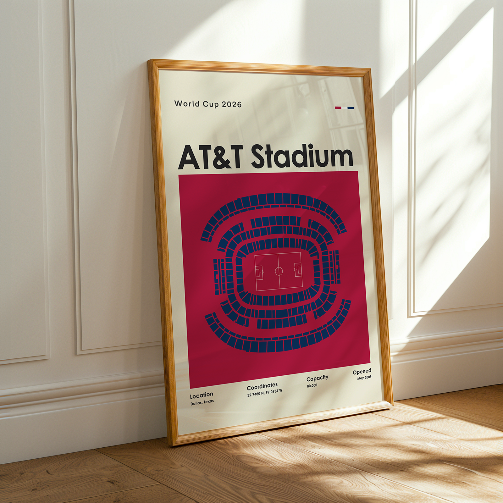 Framed poster of AT&T Stadium layout on a wall with sunlight casting shadows.