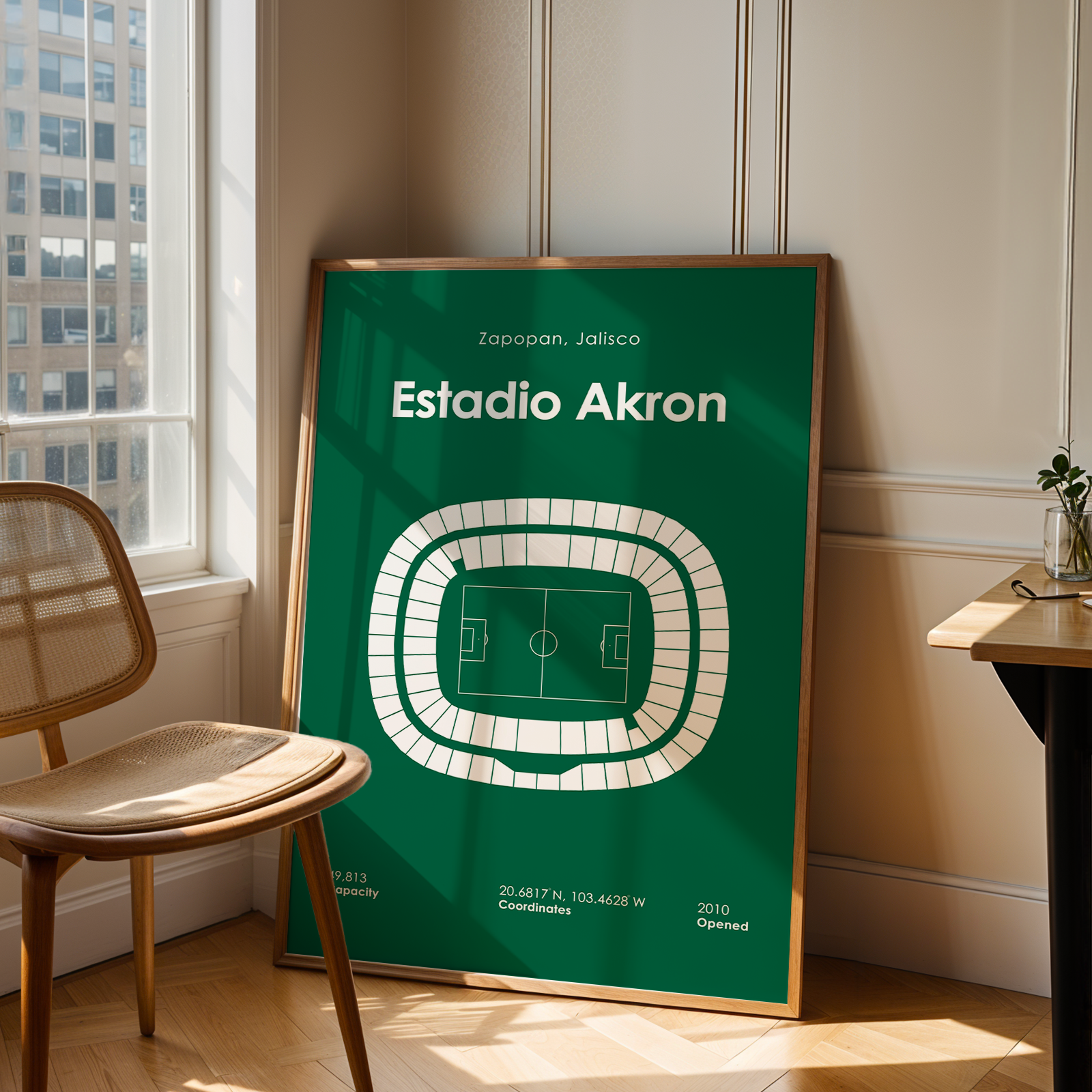 Poster of Estadio Akron in a room with a chair and table.