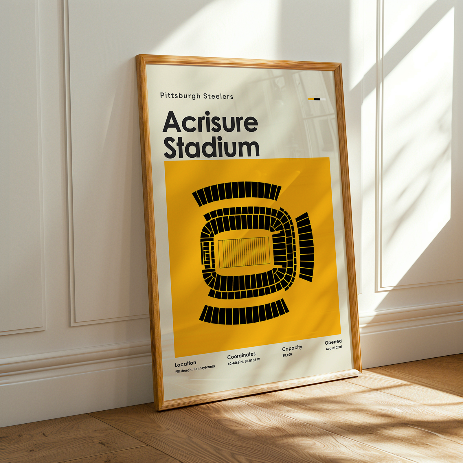 Framed poster of Acrisure Stadium with Pittsburgh Steelers text on a wall.