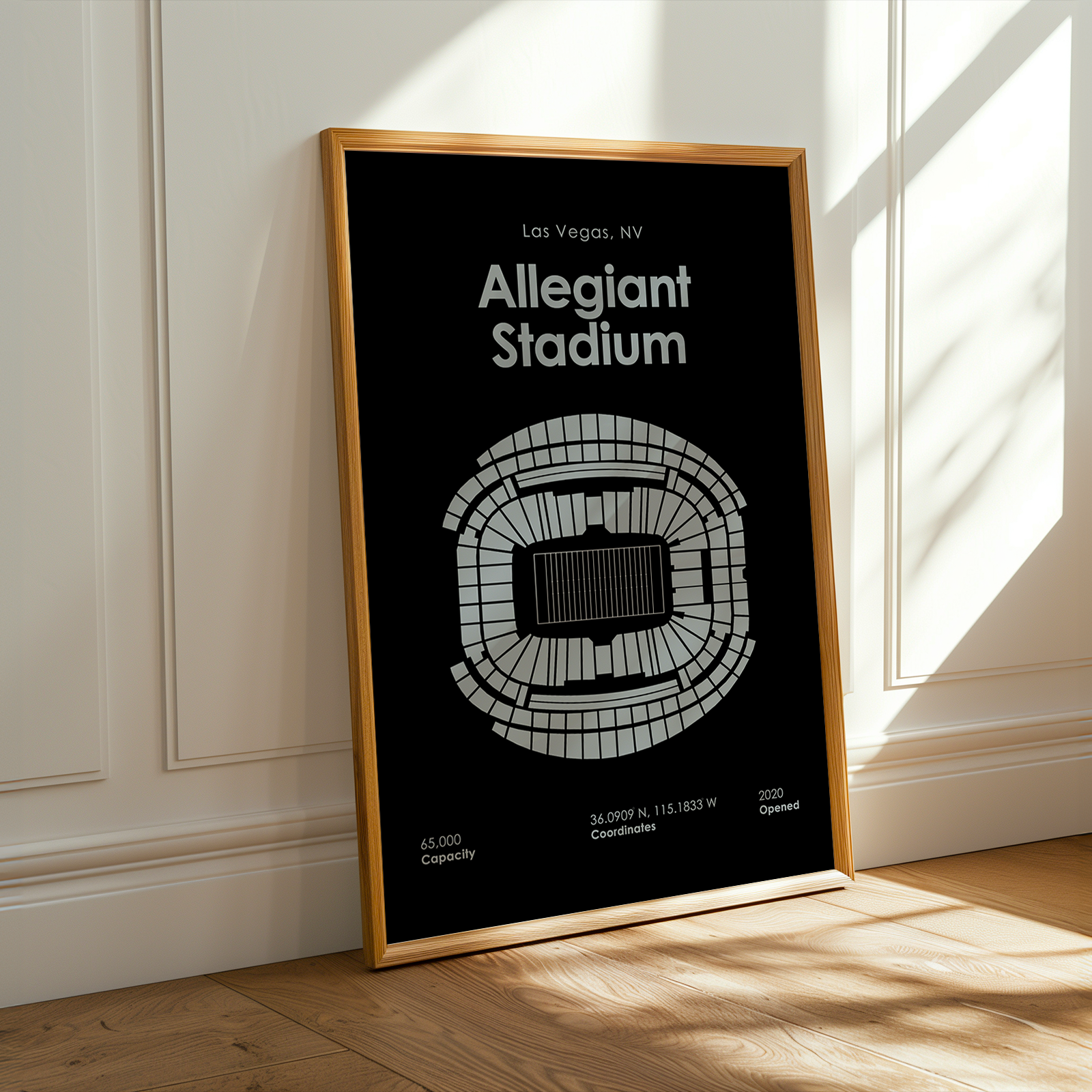Framed poster of Allegiant Stadium layout on a wall with sunlight casting shadows.
