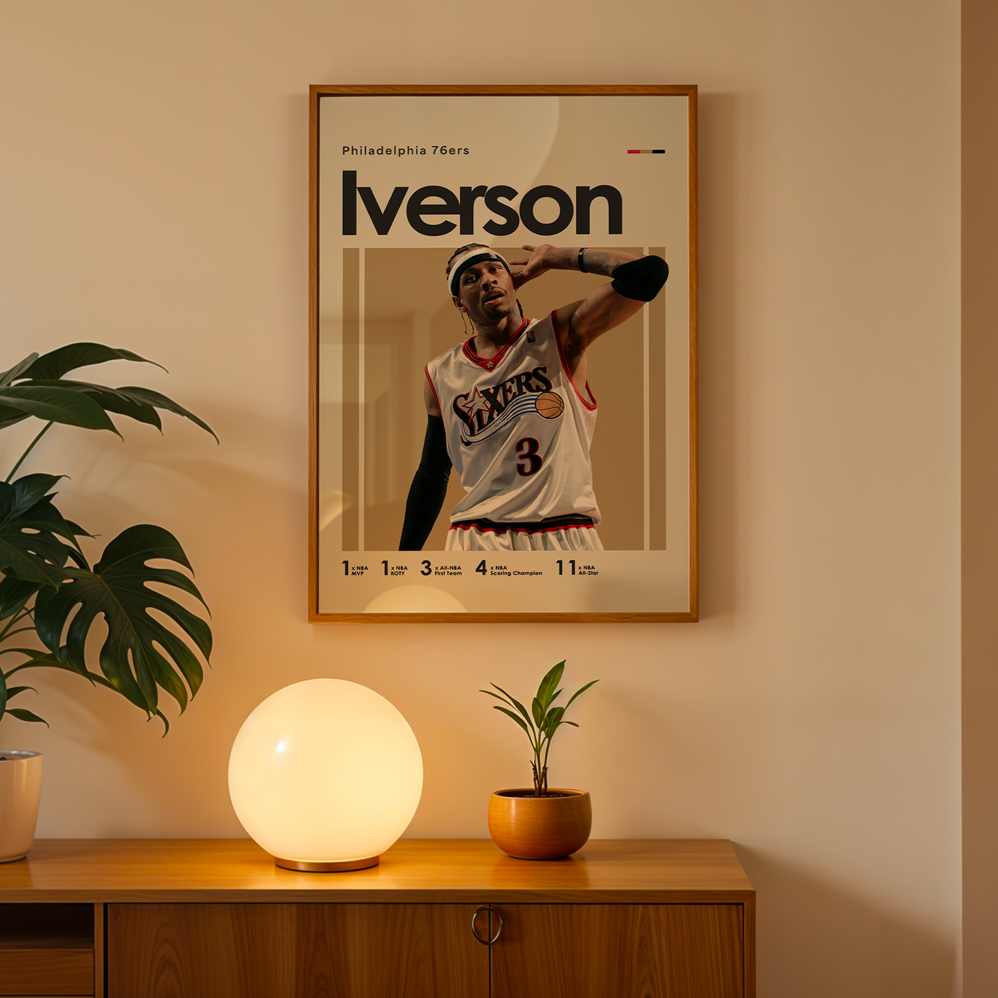 Framed poster of a basketball player on a wall above a wooden cabinet with decorative items.