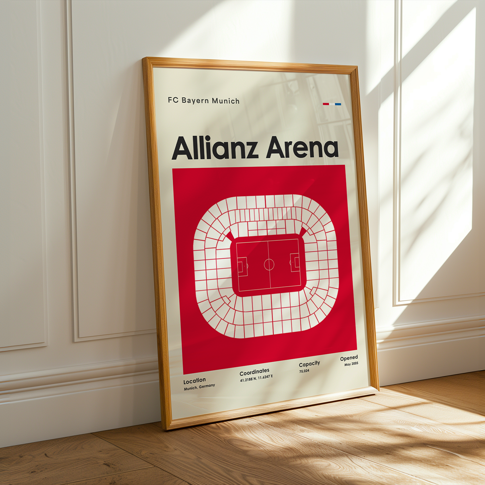 Framed poster of Allianz Arena with FC Bayern Munich branding on a wall.