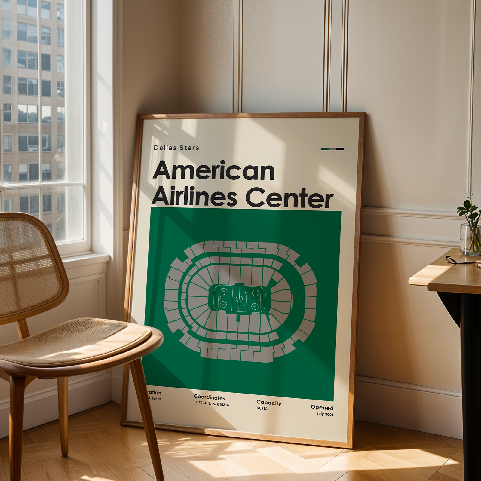 Framed poster of American Airlines Center in a room with a chair and table.